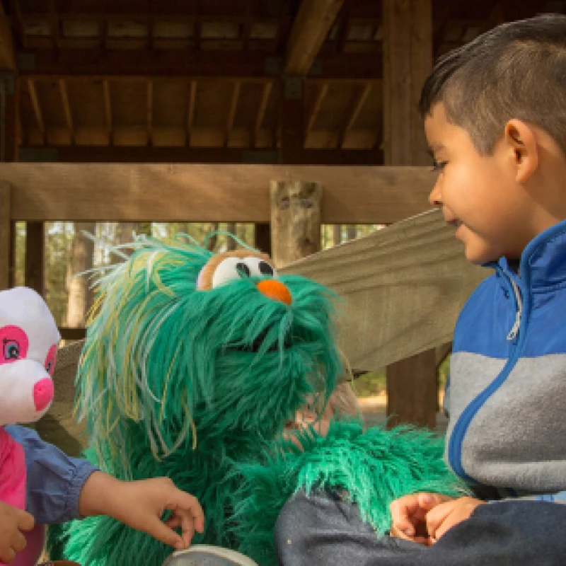 Rosita from Sesame Street talking with a child