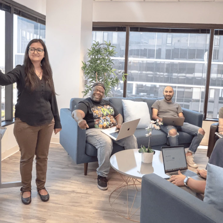 Engaging Presentation with Smiles Spokeo team watching a colleague present during a hiring review